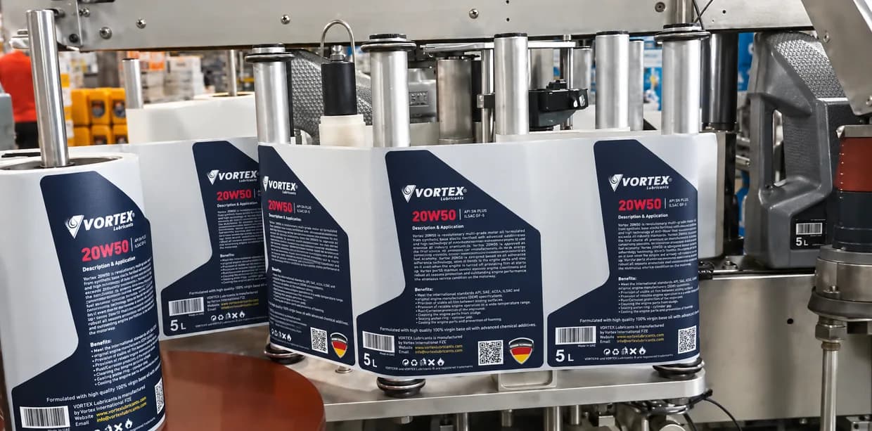 Labelled five litre VORTEX 20W50 packs leaving the labelling machine