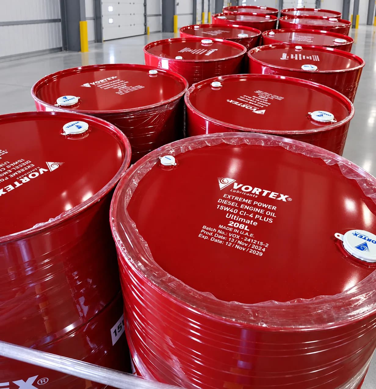 Close view of sealed red Vortex Extreme Power 15W40 drum tops under shrink wrap
